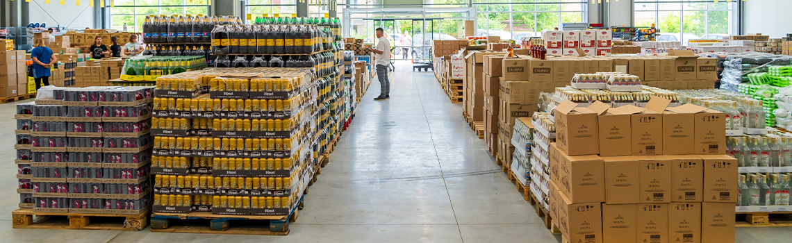 grocery store worker checking stock using automated inventory management software