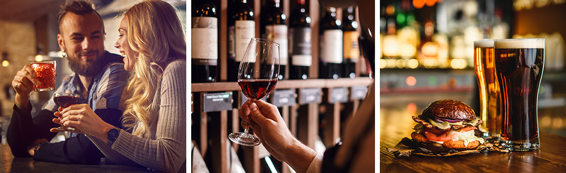 Couple enjoying drinks, wine tasting, and beer with a burger at a bar