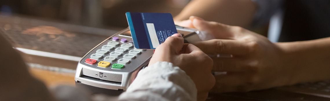 Customer making a payment with a credit card using a POS system 