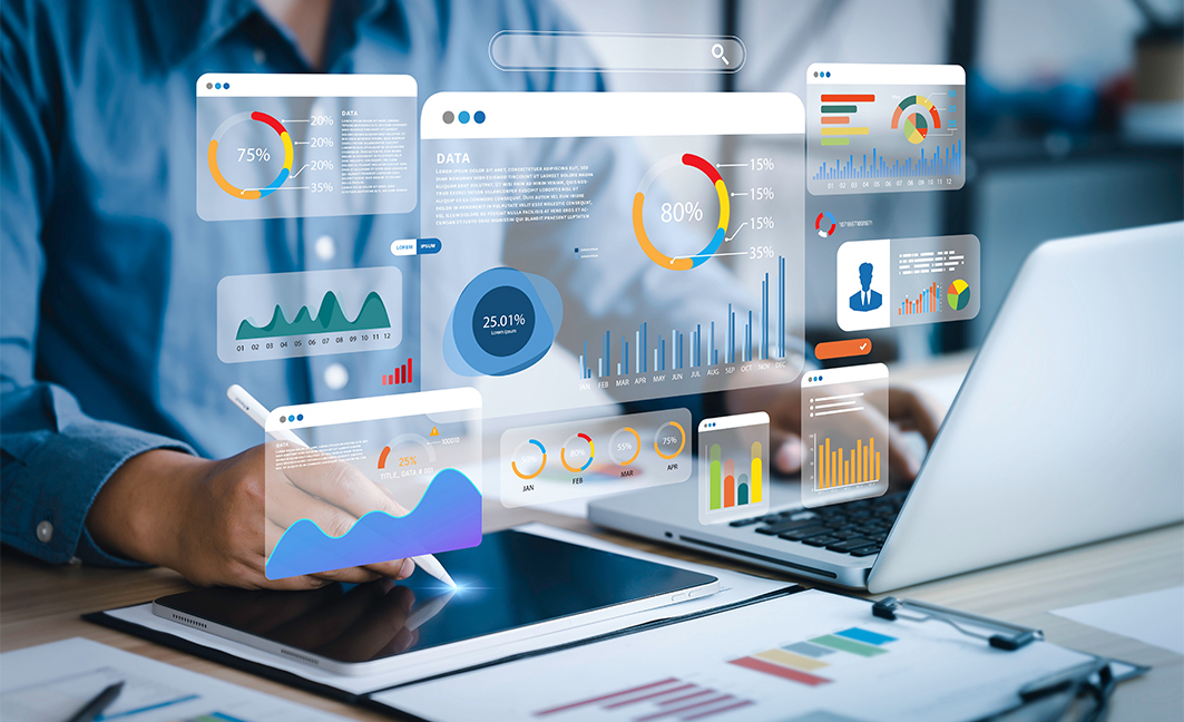 Retailer analyzing interactive data dashboards on a tablet and laptop, showcasing inventory, sales forecasting, and performance charts powered by FTx POS’s BI and custom reporting tools.